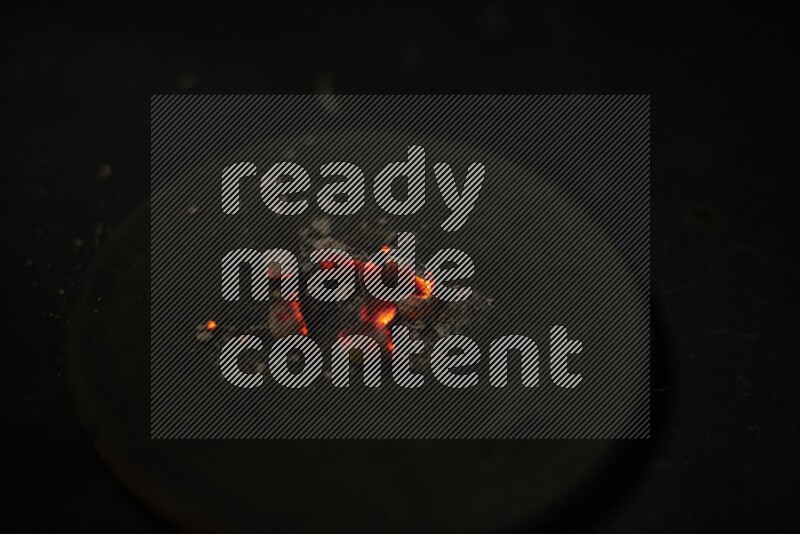Burning coal cubes on pottery plate