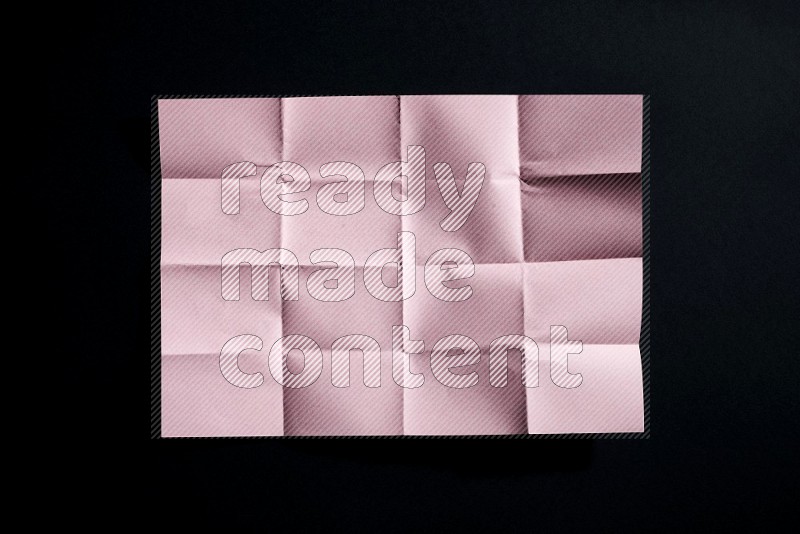 Pink paper sheet on black background