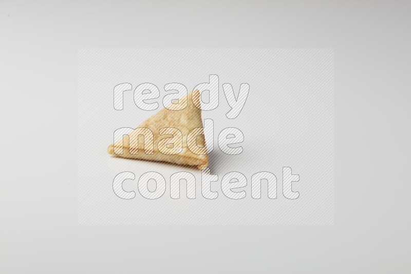 One fried sambosa on a white background