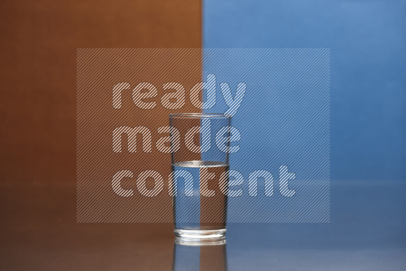 The image features a clear glassware filled with water, set against brown and blue background