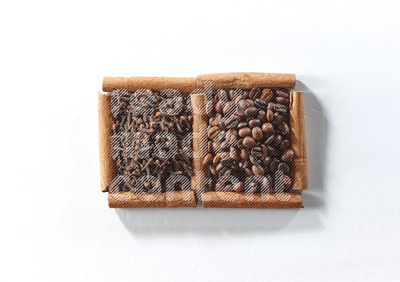 2 squares of cinnamon sticks full of coffee beans and cloves on white flooring