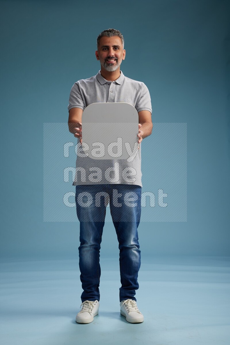 Man Standing holding social media sign on blue background