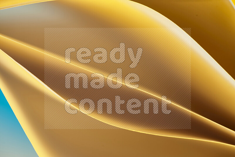 This image showcases an abstract paper art composition with paper curves in gold gradients created by colored light