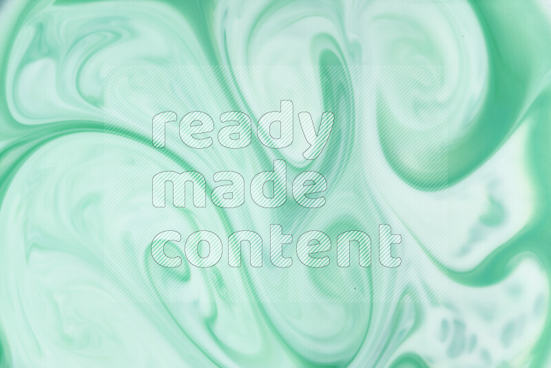 A close-up of abstract swirling patterns in green gradients
