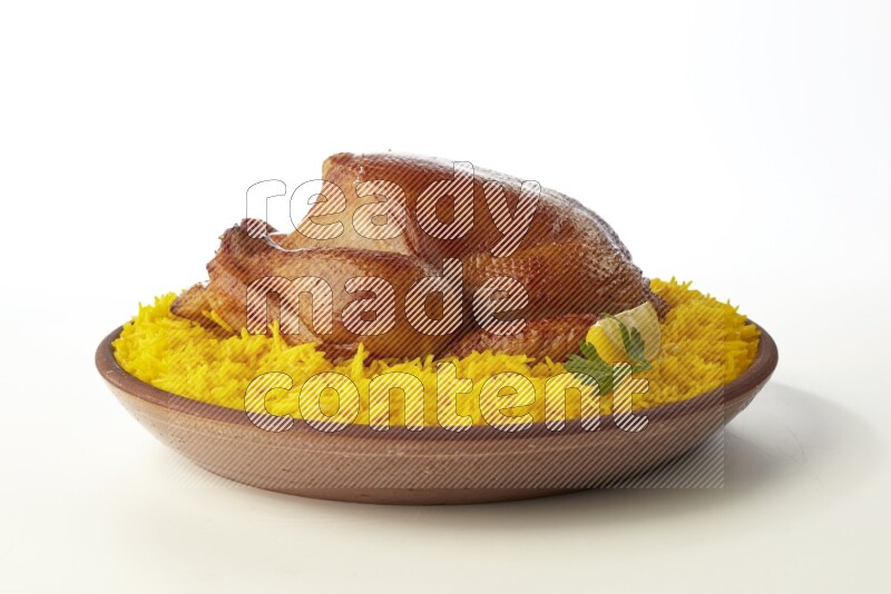 yellow basmati Rice with whole roasted chicken  on a pottery plate  direct  on white background
