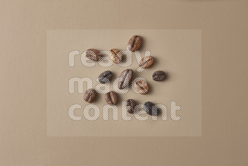 Roasted coffee beans on beige background