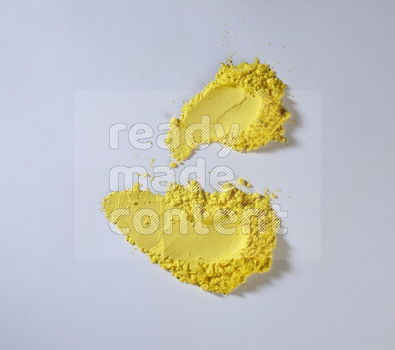 Yellow powder strokes on white background