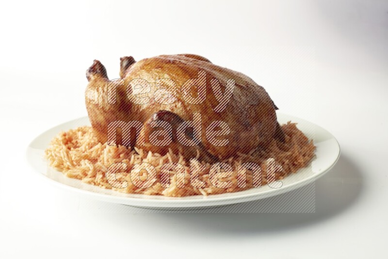 red basmati Rice with  whole roasted chicken on a white rounded plate  direct  on white background