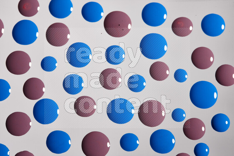 Close-ups of abstract purple and blue paint droplets on the surface