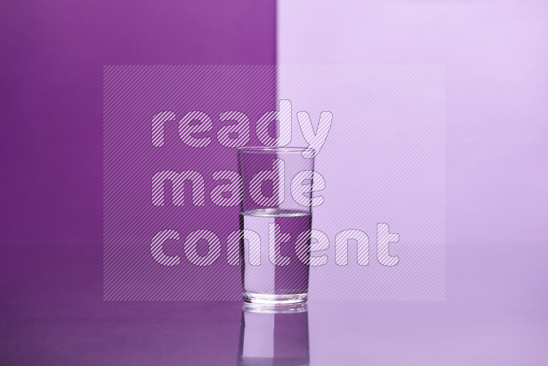 The image features a clear glassware filled with water, set against purple and light purple background