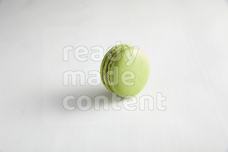 45º Shot of Green Pistachio macaron on white background