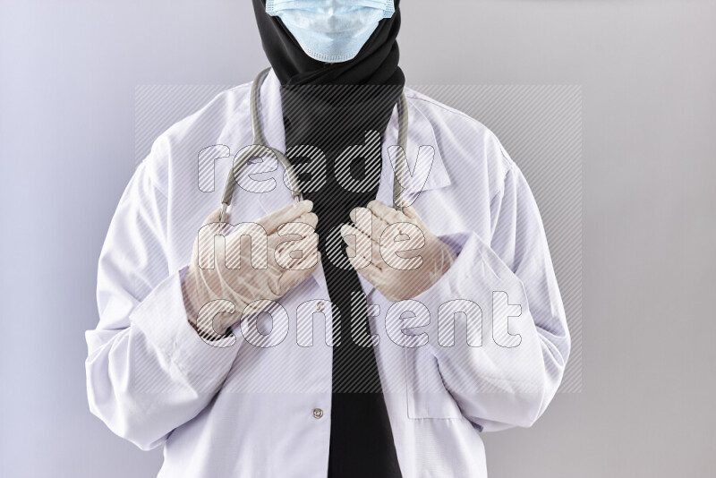 Female doctor wearing an abaya and medical attire in different positions