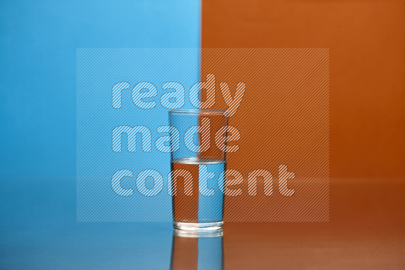 The image features a clear glassware filled with water, set against blue and dark orange background