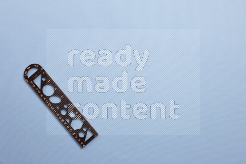 A wooden ruler on blue background