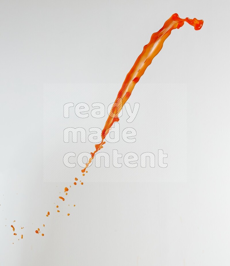 Orange liquid splash and drops on white background