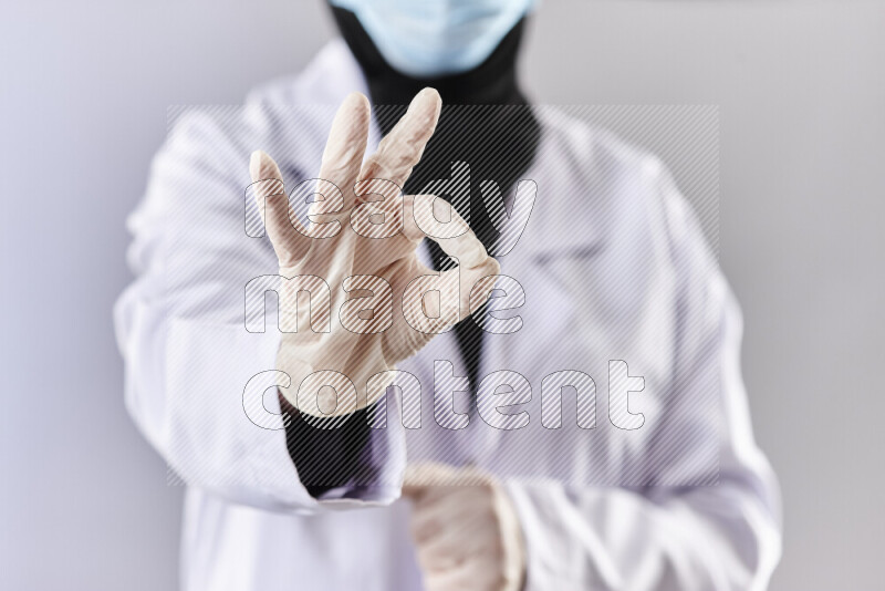Female doctor wearing an abaya and medical attire in different positions