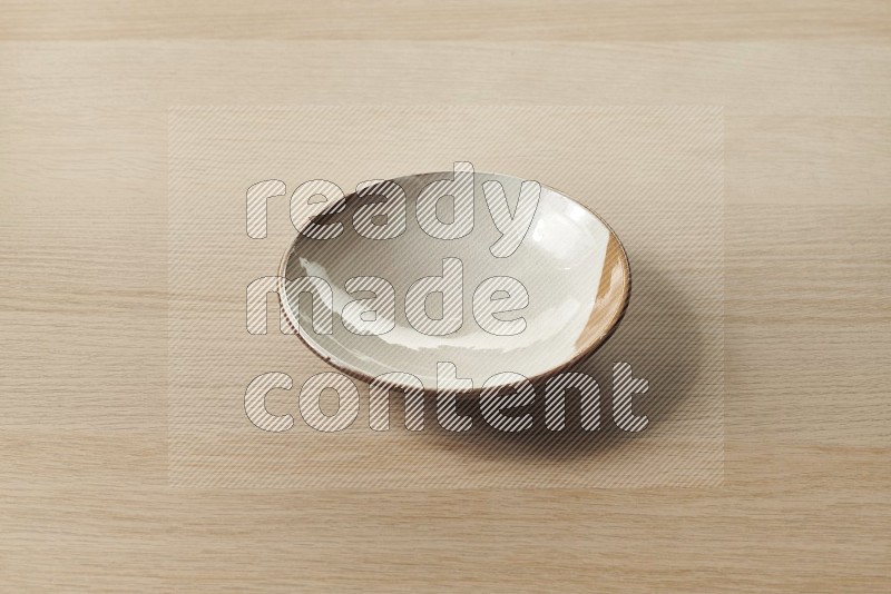 Multicolored Pottery Plate on Oak Wooden Flooring, 45 degrees