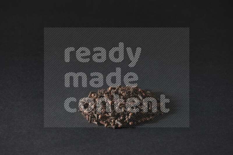 Cloves in a circle shape on a black flooring