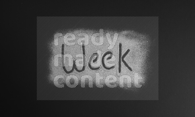 A word written with silver glitter on black background