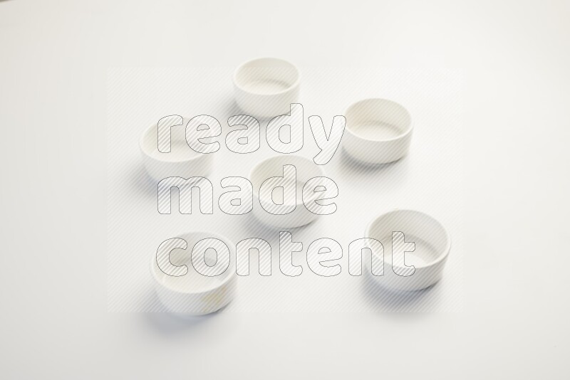 white ceramic round sauce dish on white countertop