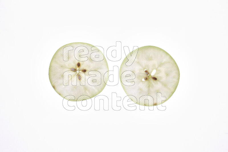 Apple slices on illuminated white background