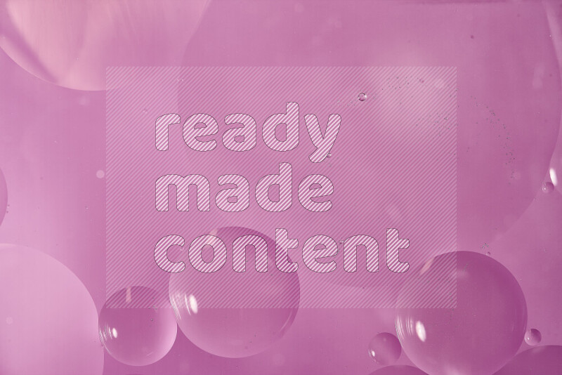 Close-ups of abstract oil bubbles on water surface in shades of pink