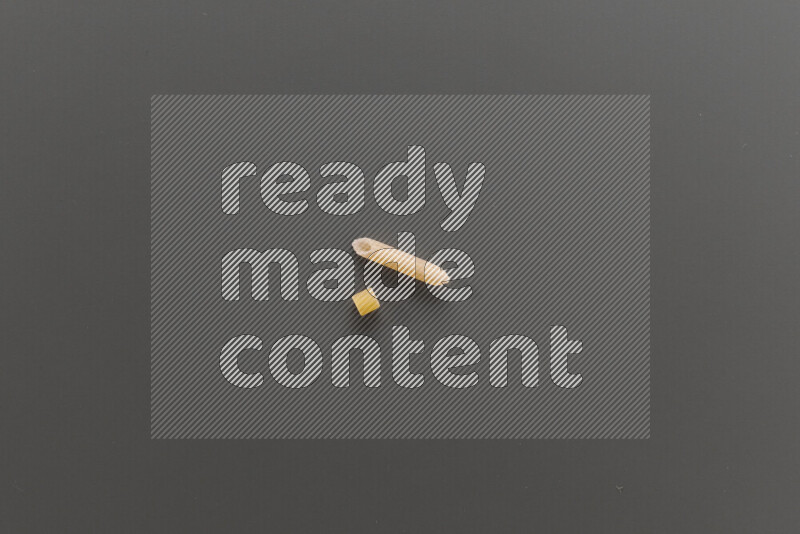 Small rings pasta with other types of pasta on grey background