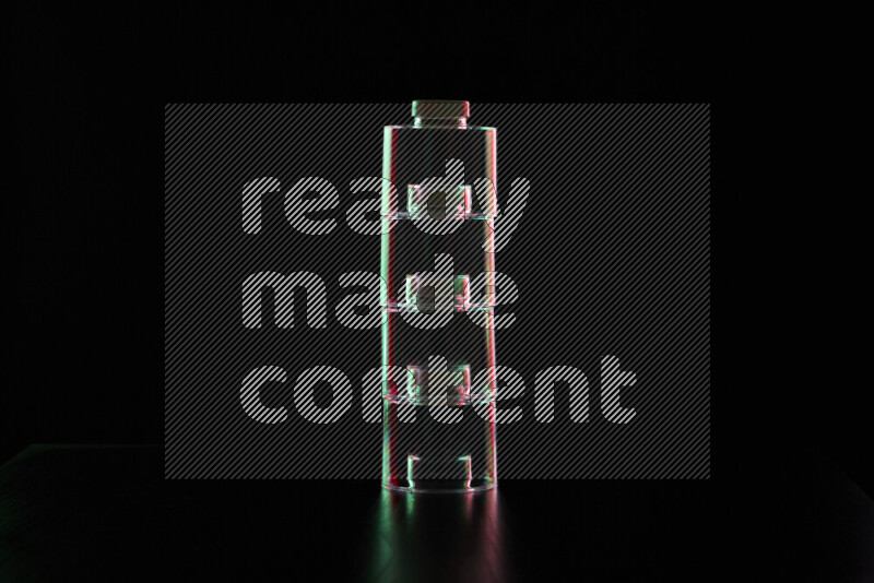 Glassware with rim light in red and green against black background