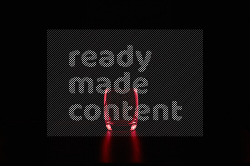 Glassware with rim light in red against black background