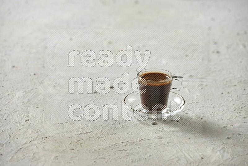 A coffee glass cup with dates and tea on textured white background
