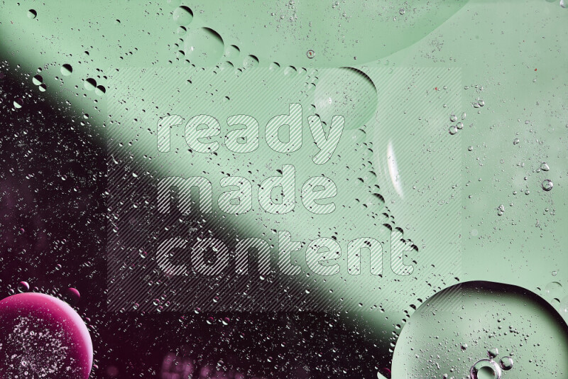 Close-ups of abstract oil bubbles on water surface in shades of green and pink