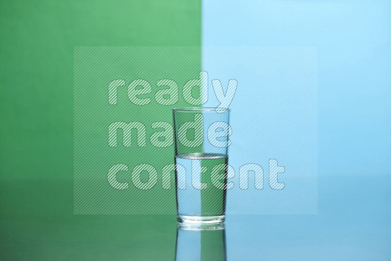 The image features a clear glassware filled with water, set against green and light blue background