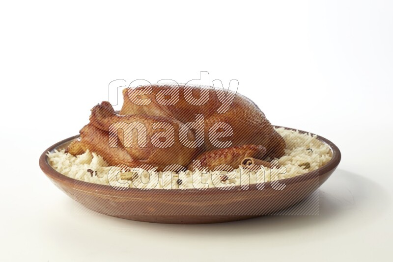 white  basmati Rice with  whole roasted chicken    on a pottery plate  direct  on white background