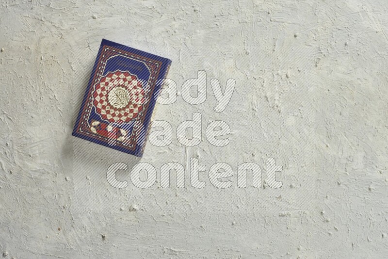 Quran with a prayer beads on white background