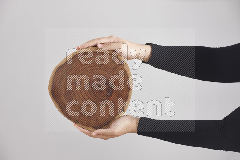A woman in black abaya holding different wooden essentials in different positions