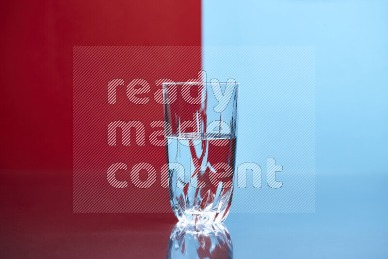 The image features a clear glassware filled with water, set against red and light blue background