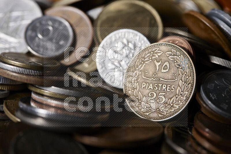 A close-ups of random old coins on black background