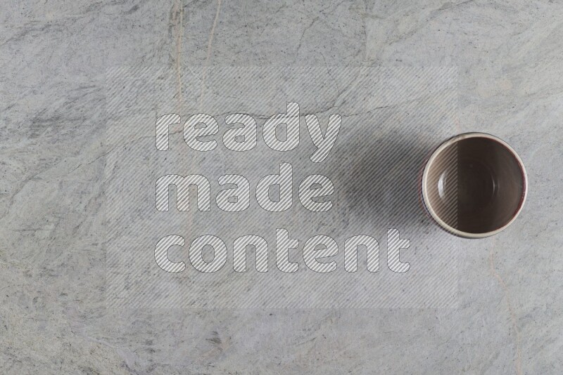 A multicolored pottery Bowl on grey marble background