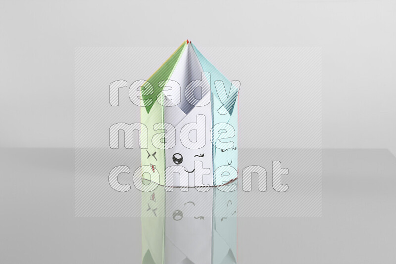 Origami pen holder on grey background