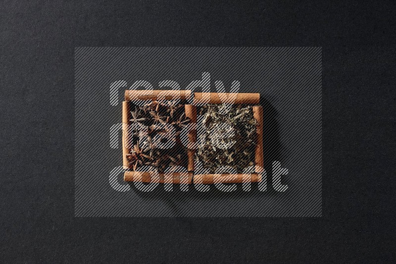 2 squares of cinnamon sticks full of star anise and dried basil on black flooring