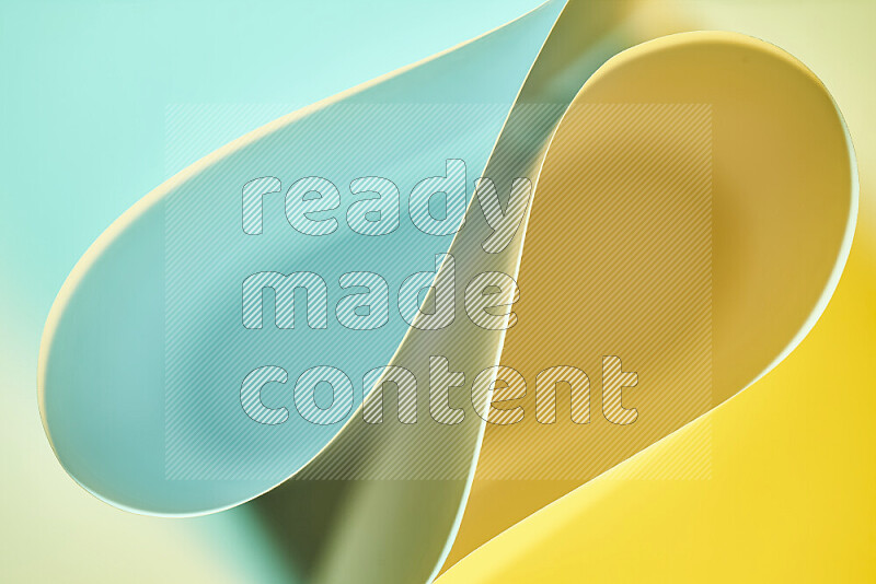 An abstract art of paper folded into smooth curves in green and yellow gradients