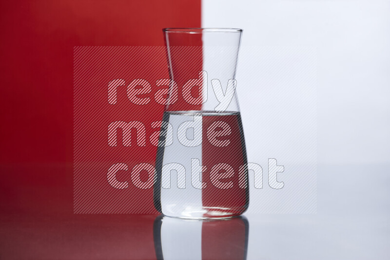 The image features a clear glassware filled with water, set against white and red background