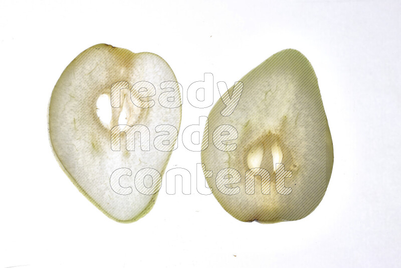 Pear slices on illuminated white background