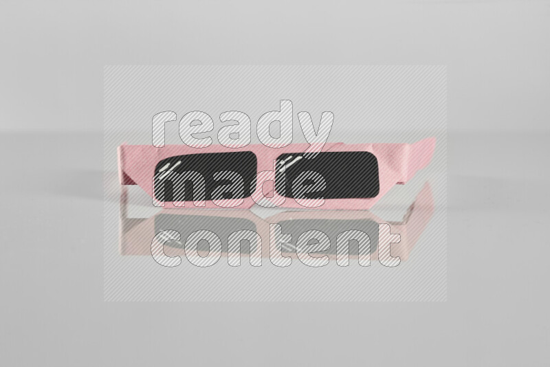 Origami sun glasses on grey background
