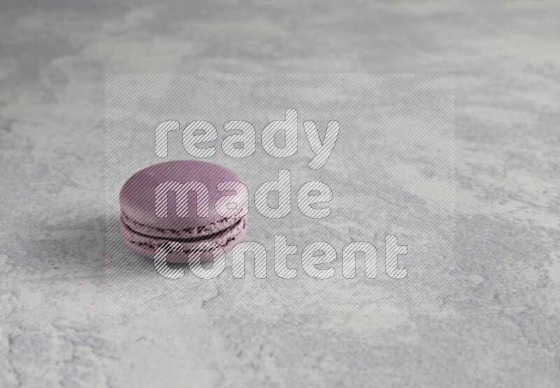 45º Shot of Purple Blueberry macaron on white  marble background