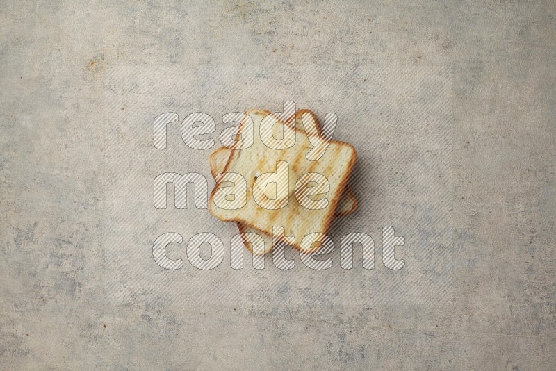 Toasted White Toast slices with a butter curl on a light blue textured background