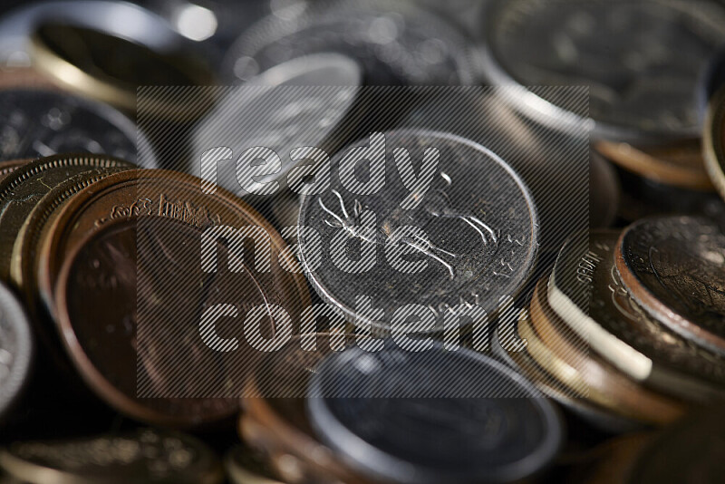 A close-ups of random old coins on black background