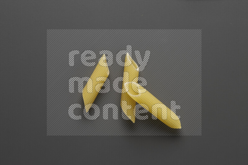 Penne pasta on grey background