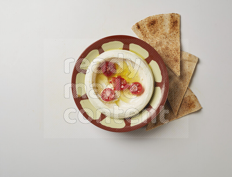 Lebnah garnished with Cherry tomato in a traditional plate on a white background
