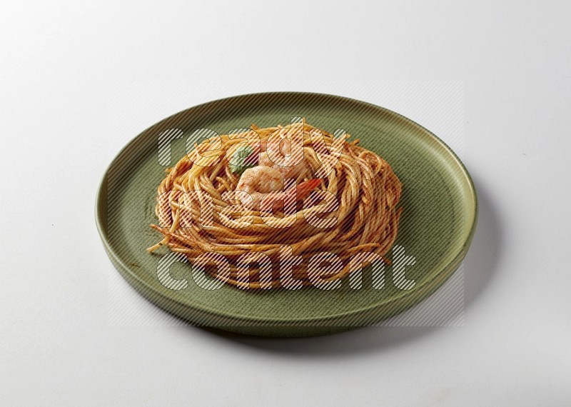 spaghetti pasta with red sauce on a green plate on a white background